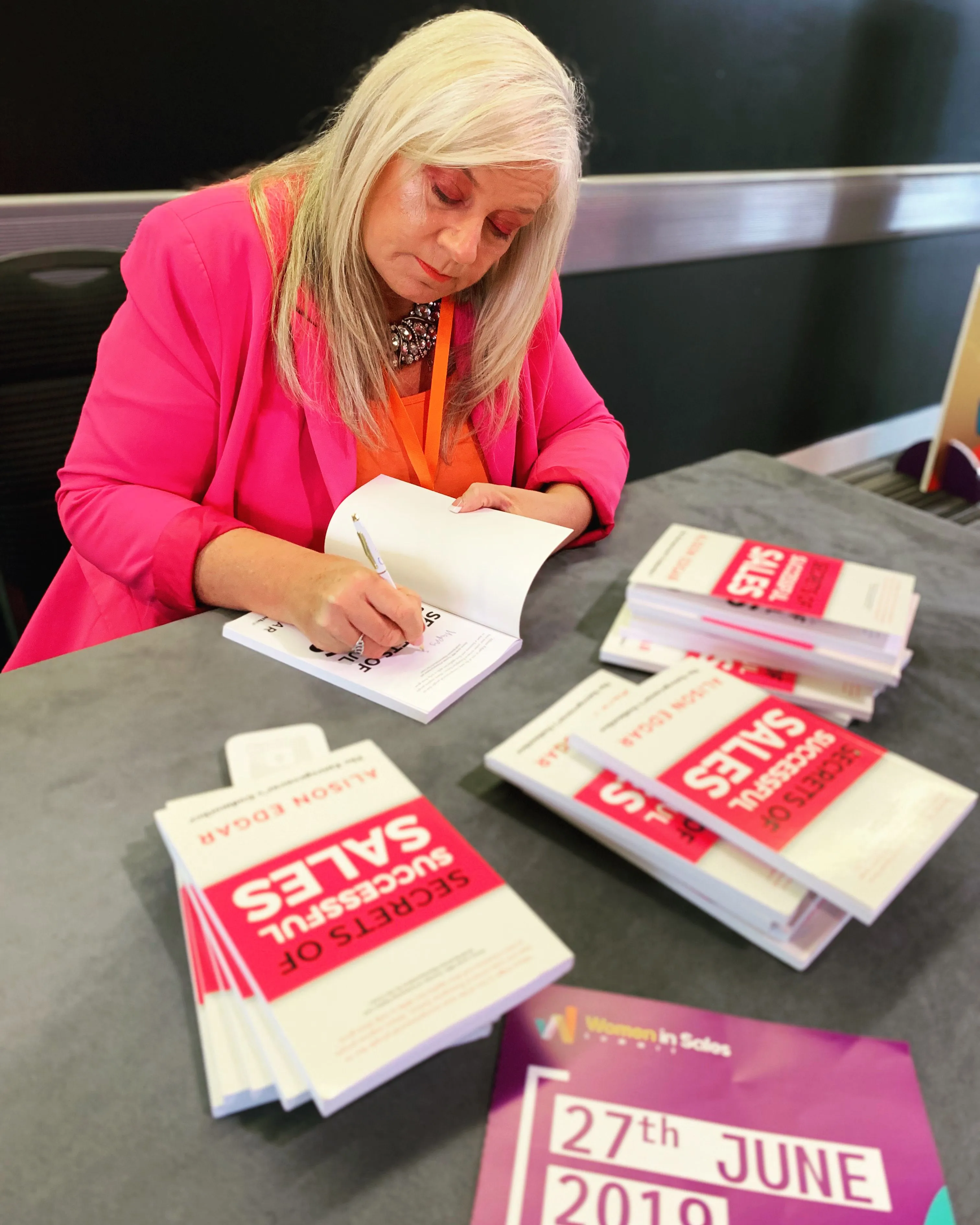 Alison signing copies of her first book, Secrets of Successful Sales.