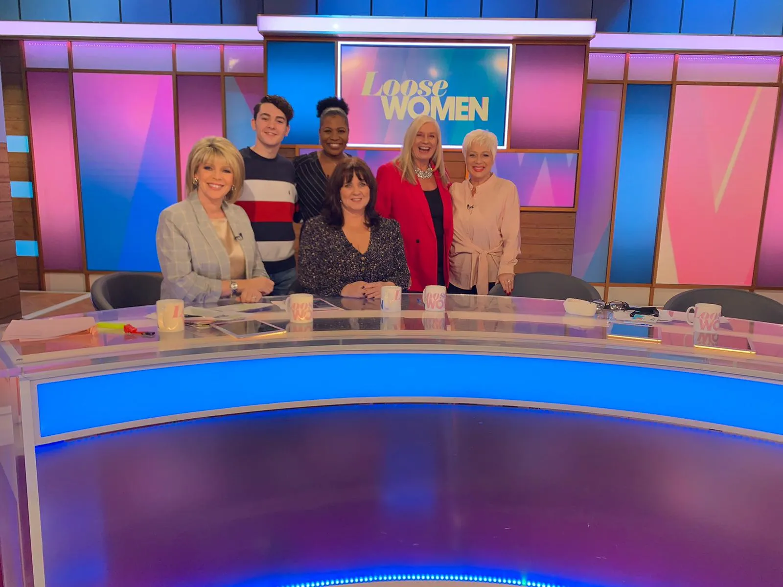 Alison with the Loose Women panellists at the desk of the Loose Women studio.