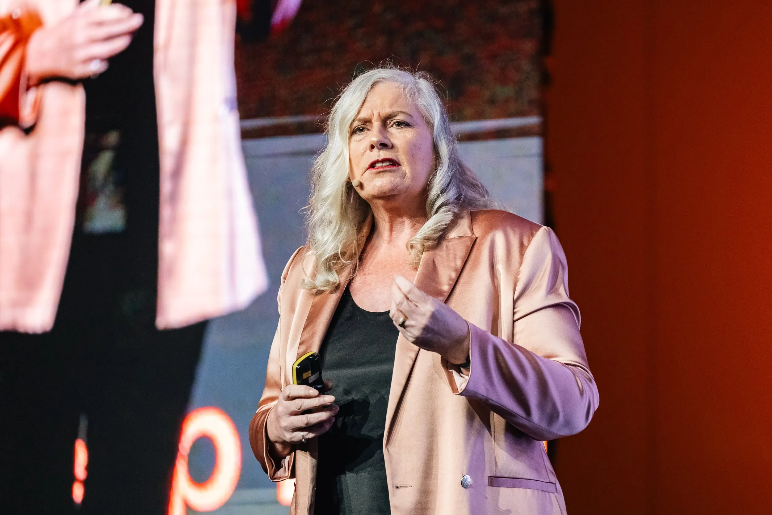 Dr Alison Edgar MBE delivering a keynote on stage